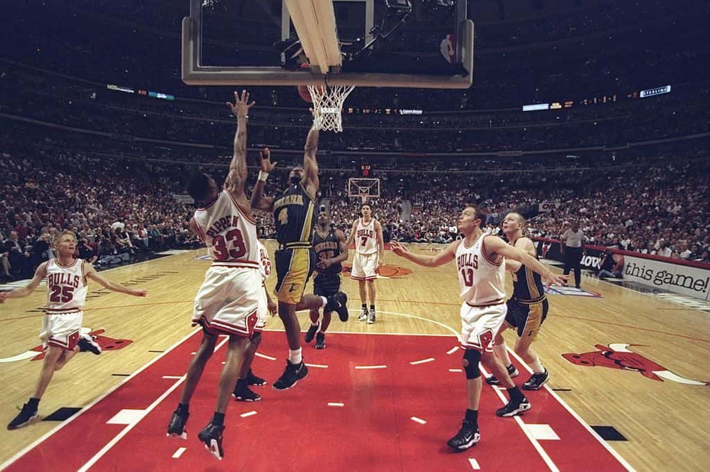Travis Best #4 of the Indiana Pacers shoots over Scottie Pippen #33 of the Chicago Bulls during an Eastern Conference Final game at the United Center in Chicago, Illinois.