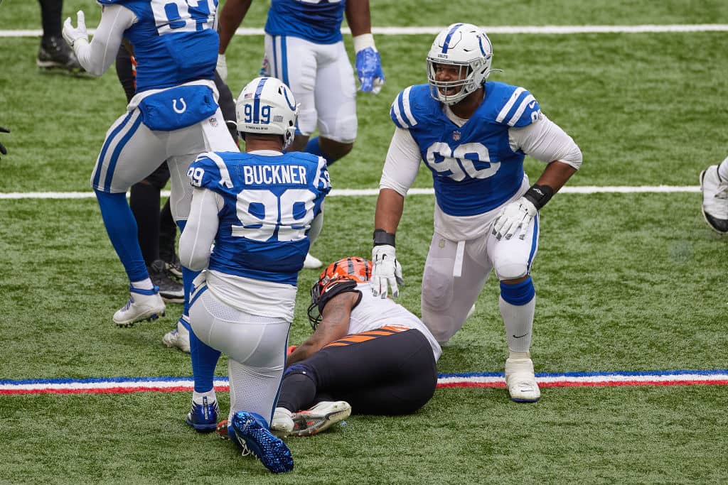 Colts DeForest Buckner and Grover Stewart react after a play.