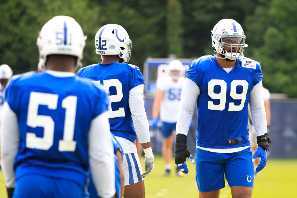 DeForest Buckner stretches and gets ready for practice along with Kwity Paye and Ben Banogu
