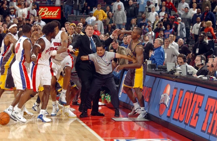 Ben Wallace of the Pistons and teammates are kept apart from Ron Artest of the Pacers by Indianaa head coach Rick Carlisle and official Tommy Nunez Jr on 19 November 2004. Photograph: Allen Einstein/NBAE/Getty Images